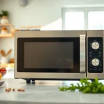 Cooking with a modern microwave oven displaying fresh ingredients and a bright kitchen backdrop.