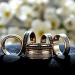 Elegant tungsten wedding bands on velvet cushion, showcasing intricate designs and polished surfaces.